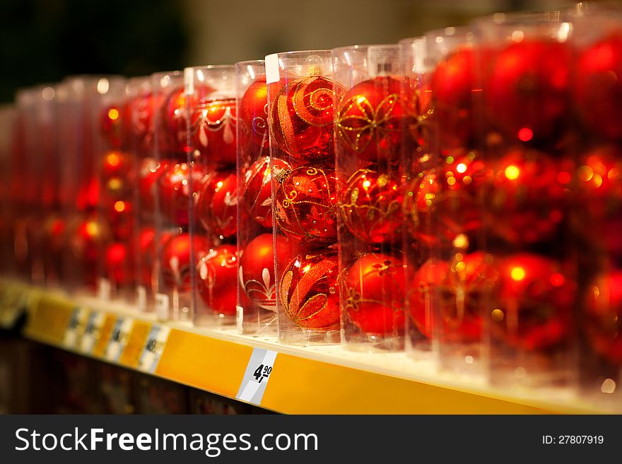 Line of xmas baubles on shelfs in hypermarket. Line of xmas baubles on shelfs in hypermarket