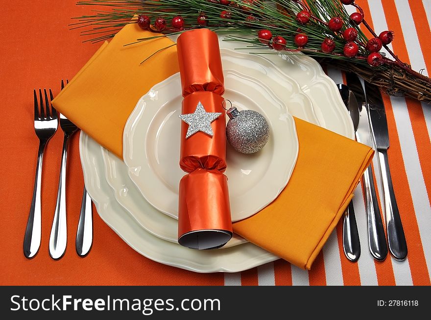 Bright and colorful Christmas table setting with plates, forks and knives, Christmas Bon Bons Crackers with decorations for a lively, stylish and fun holiday party atmosphere. Bright and colorful Christmas table setting with plates, forks and knives, Christmas Bon Bons Crackers with decorations for a lively, stylish and fun holiday party atmosphere.