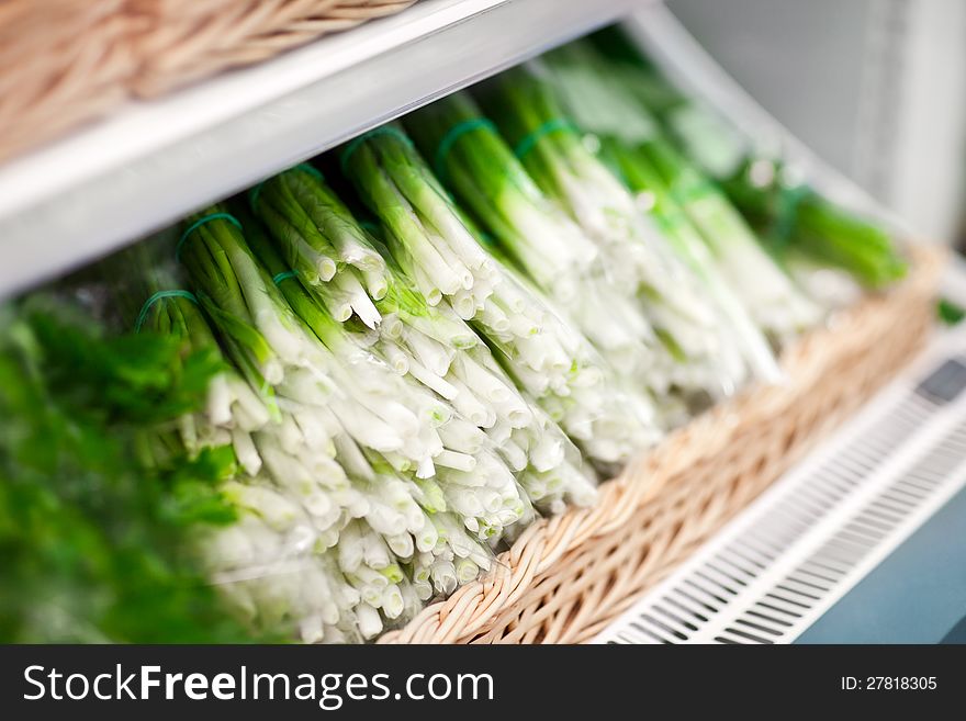 Fresh green onion in box in supermarket. Fresh green onion in box in supermarket