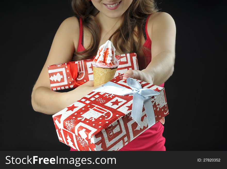 Cute  girl  holds  gift boxes and ice cream. Cute  girl  holds  gift boxes and ice cream