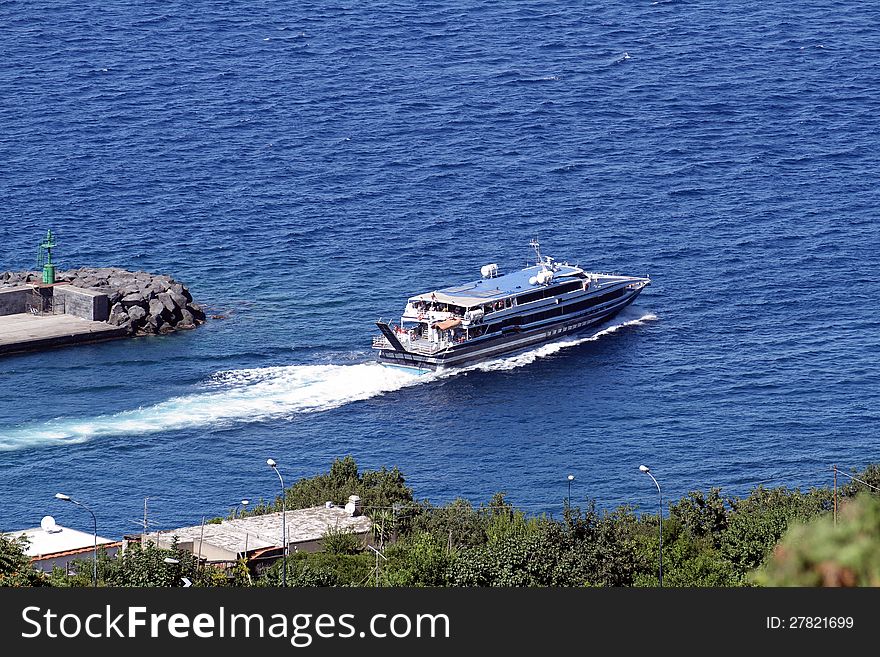 Coastal cruise from Capri Island to Naples leaving port.
