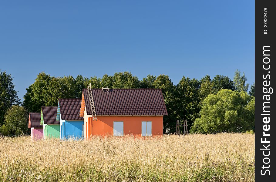 Multicolored houses in the field