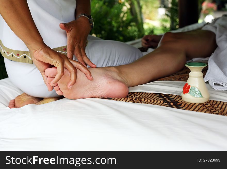 A detail image of a female leg being massaged. A detail image of a female leg being massaged