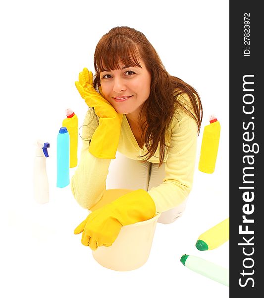 Smiling woman on the floor with plastic bucket and many bottles around her, isolated on a white background. Smiling woman on the floor with plastic bucket and many bottles around her, isolated on a white background.