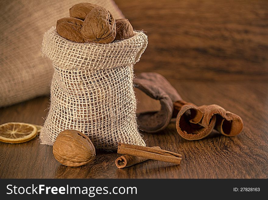 Nuts in burlap sack on wooden table. Nuts in burlap sack on wooden table