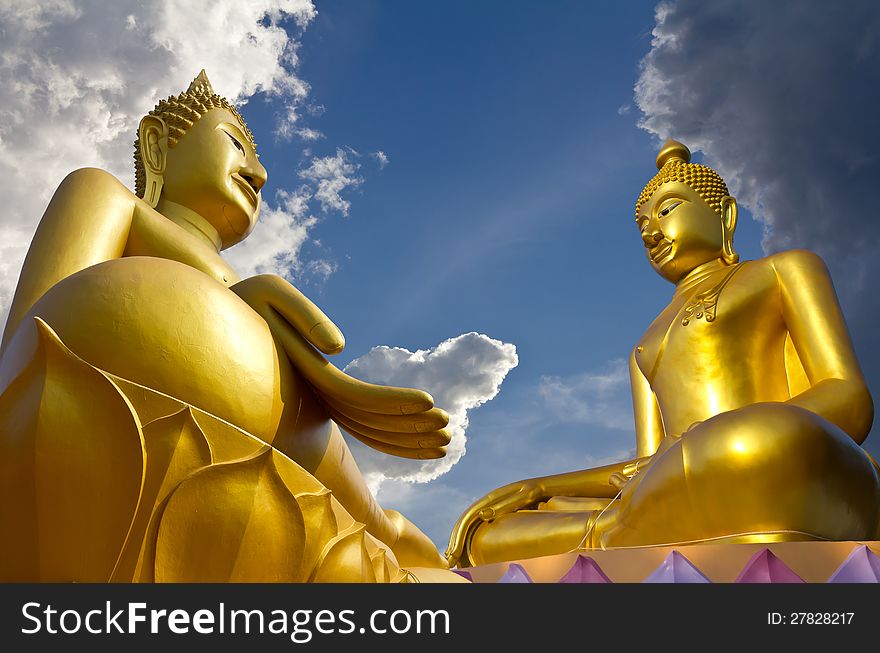 Two large statues of Buddha pagoda concentrate on clouds and sky. Two large statues of Buddha pagoda concentrate on clouds and sky.