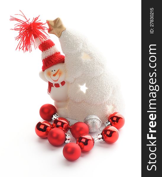 Snowman in Knitted Hat, Snow House and Red Little Baubles closeup on white background. Snowman in Knitted Hat, Snow House and Red Little Baubles closeup on white background