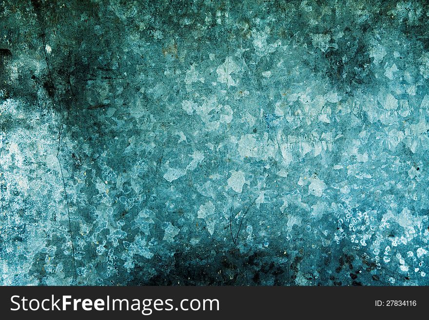 Stained rusty wall background in hues of dark blue