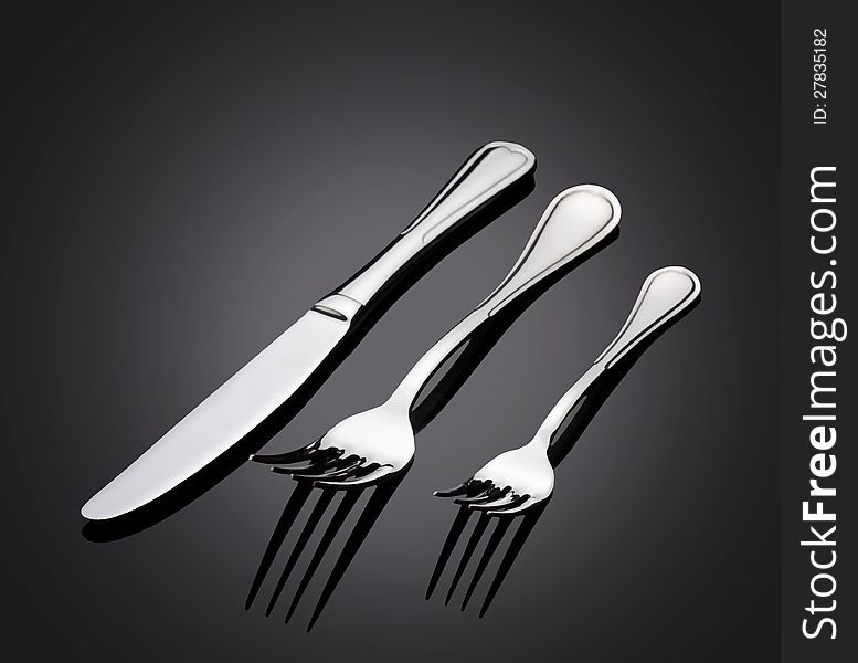 Shiny metal cutlery on dark background. Shiny metal cutlery on dark background