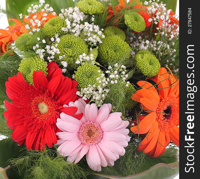 Bright bouquet shot from above, close-up. Gerbera. Red, orange, rose, green flower