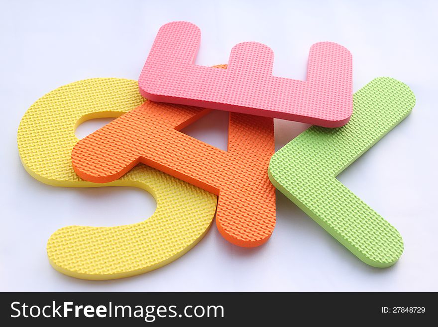 Letters from a textured material on the white background