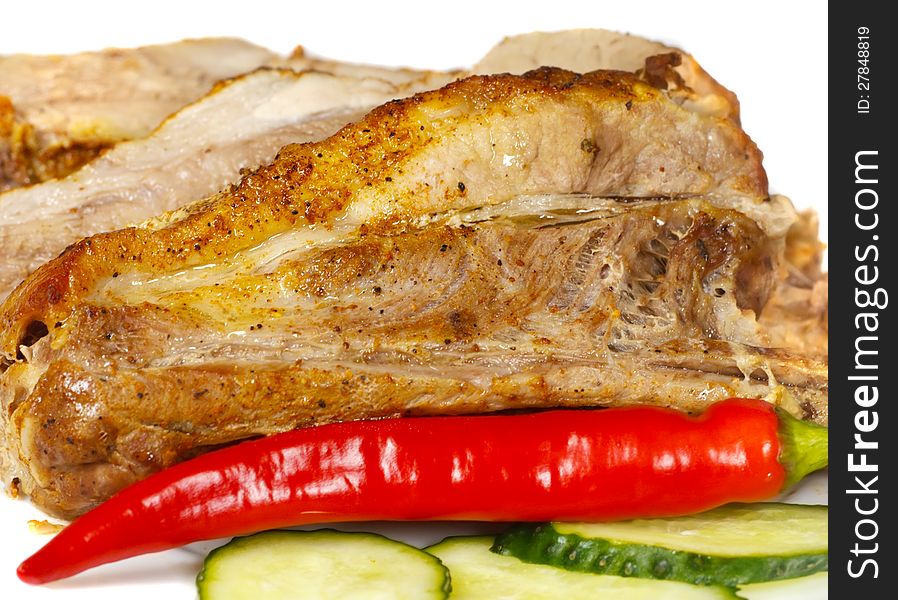 Baked meat on a plate with vegetables