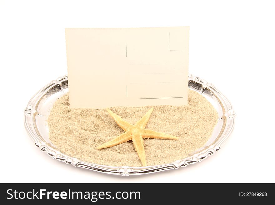 Serving plate of postcard and shell on the sand of the sea. Serving plate of postcard and shell on the sand of the sea.