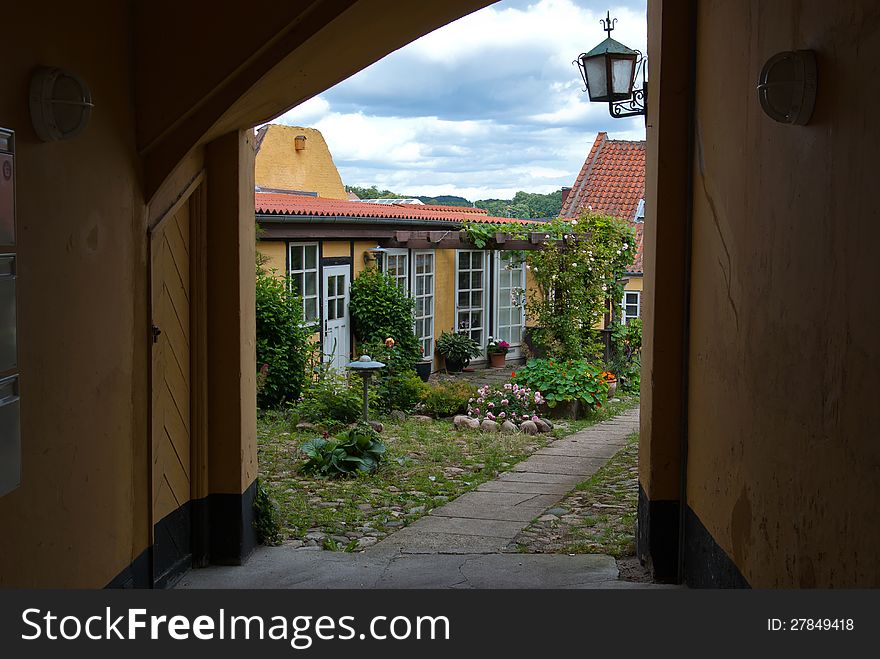 Traditional classical Danish small city house blooming garden. Traditional classical Danish small city house blooming garden