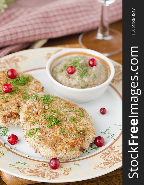 Chicken cutlets with cowberry and mushroom sauce closeup selective focus