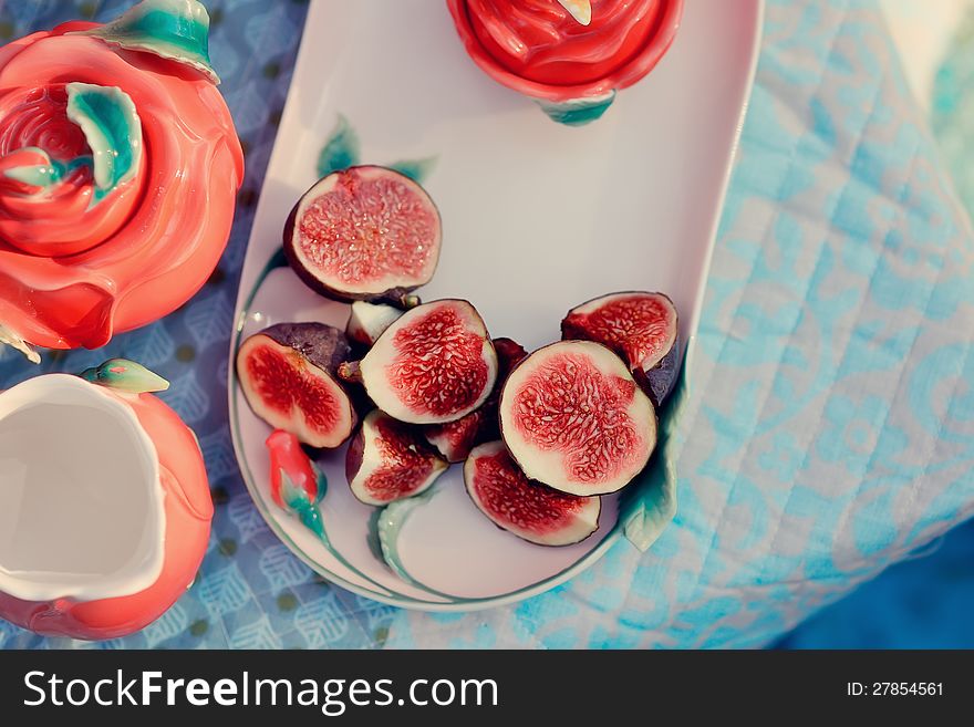 Still life - red, juicy pomegranate and fresh, ripe figs. Still life - red, juicy pomegranate and fresh, ripe figs