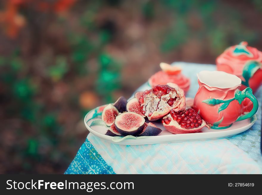 Still life - red, juicy pomegranate and fresh, ripe figs. Still life - red, juicy pomegranate and fresh, ripe figs