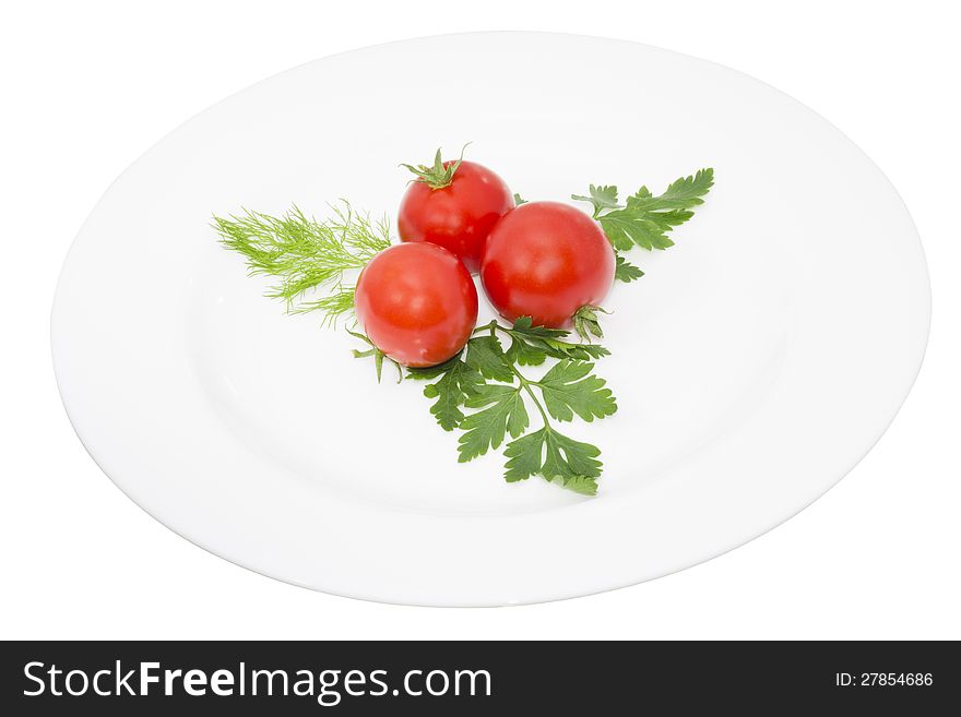 Tomato and greens in a plate, isolated