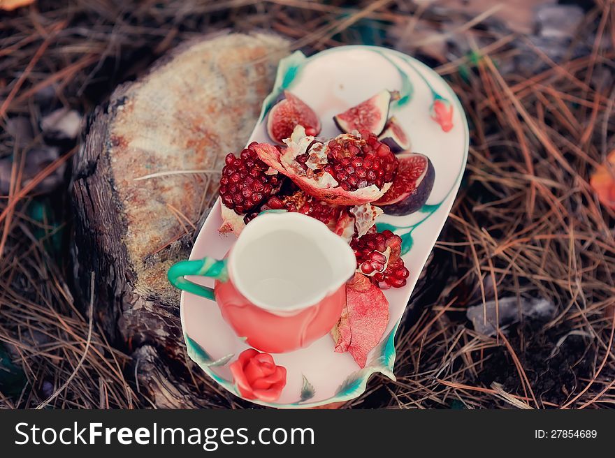 Still life - red, juicy pomegranate and fresh, ripe figs. Still life - red, juicy pomegranate and fresh, ripe figs