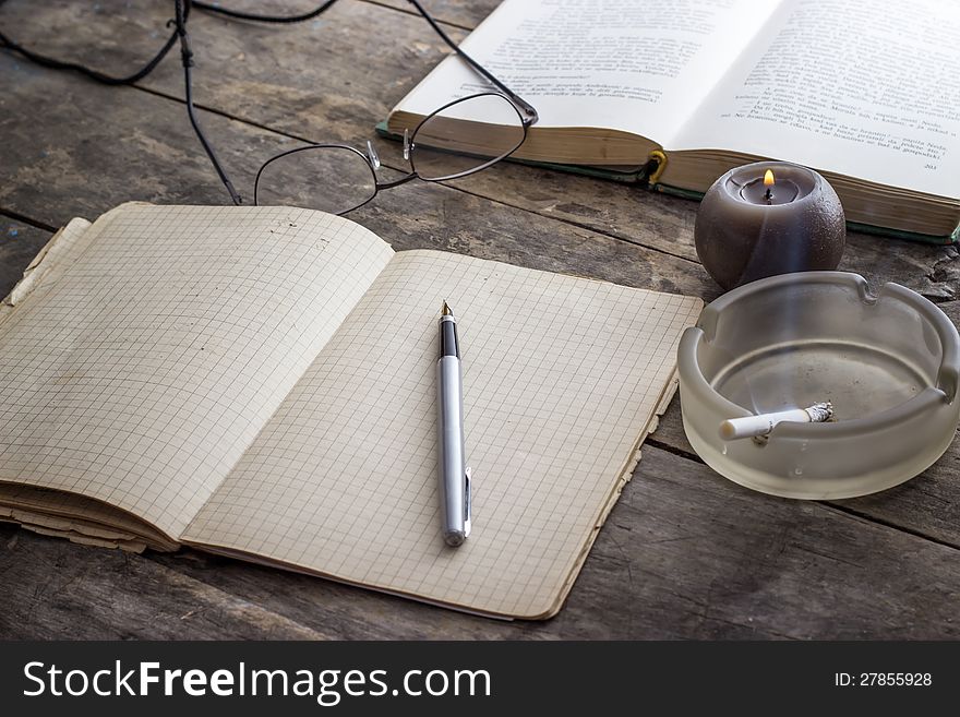 Books and Candle on wooden table