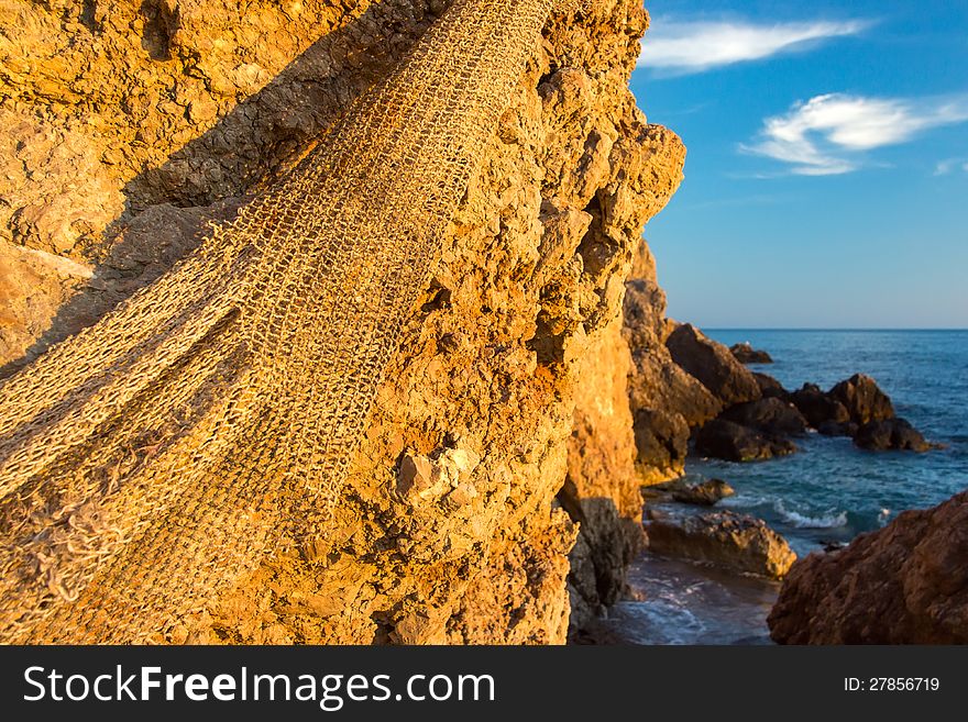 Fishing net hanging on the stone. Fishing net hanging on the stone