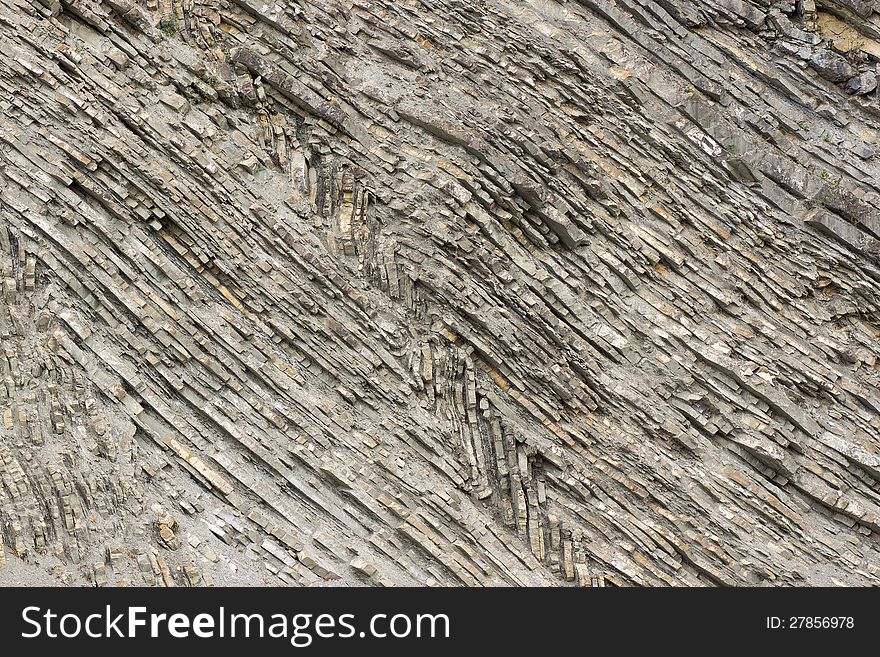 Textured background of natural stone forms a ribbed. Textured background of natural stone forms a ribbed