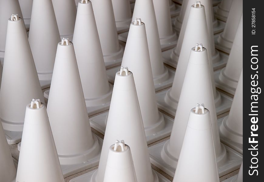 White cone warning signs standing in a row. White cone warning signs standing in a row