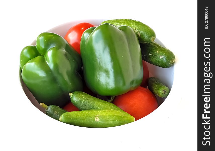 Summer vegetables of capsicums, tomatoes and cucumbers within a plate