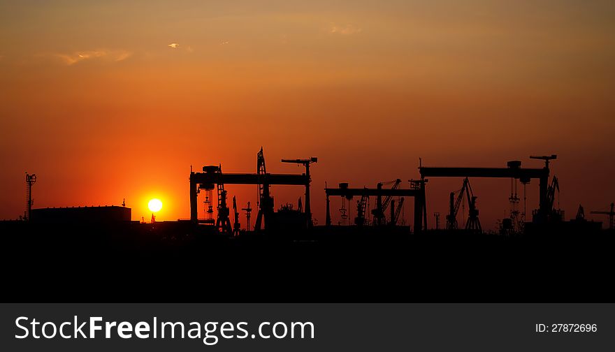 Naval industial camp with cranes at sunset. Naval industial camp with cranes at sunset