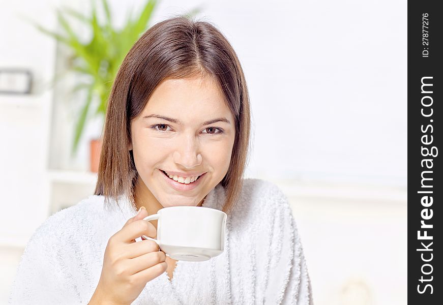 Woman in bathrobe relaxing at home