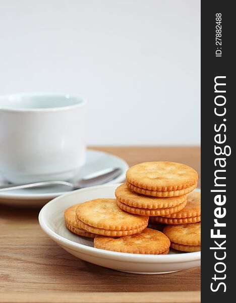 Cracker and a cup of coffee isolated on white background