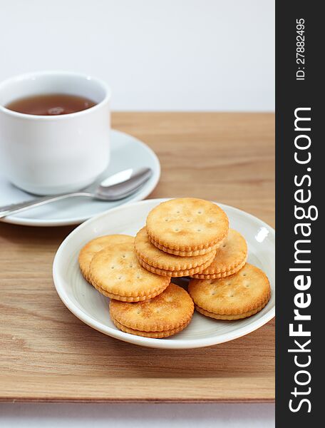 Cracker and a cup of tea isolated on white background. Cracker and a cup of tea isolated on white background