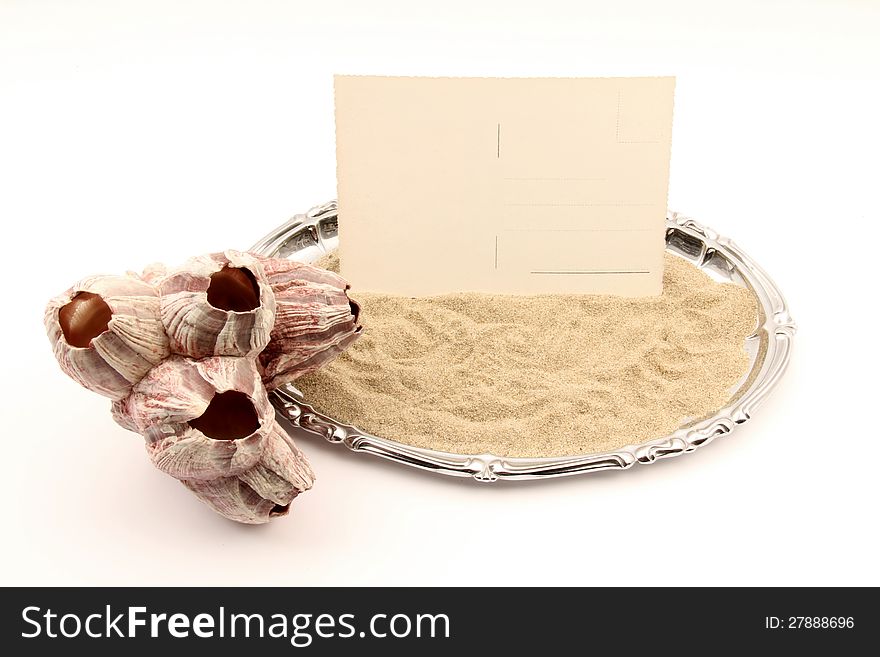 Serving tray with a postcard in the sand and a seashell. Serving tray with a postcard in the sand and a seashell.