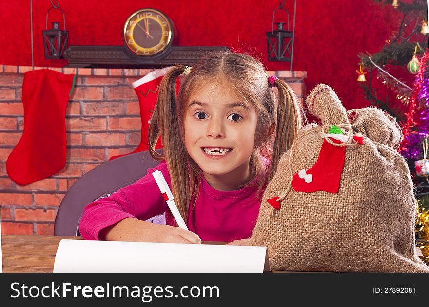 Happy child writes letter to Santa Claus