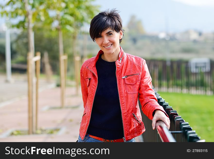 Portrait of a beautiful woman smiling in urban background. Portrait of a beautiful woman smiling in urban background