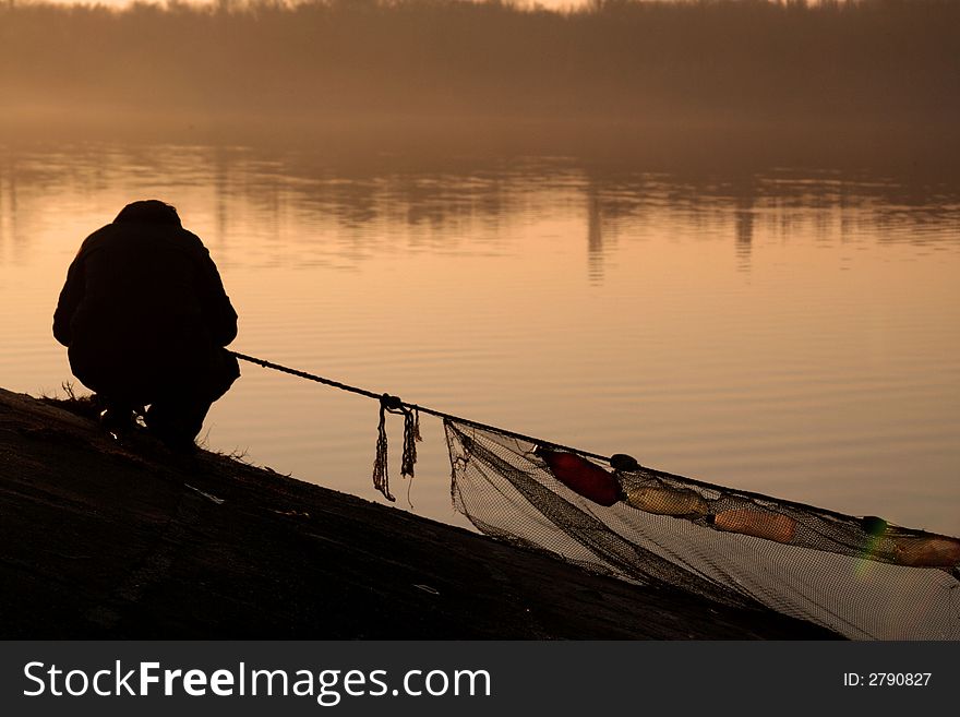 An old fisherman at the sunset