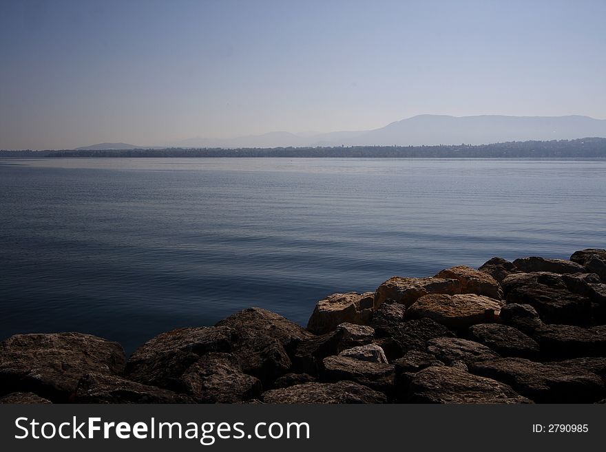 Serene Lake with Rocks and Blue Sky. Serene Lake with Rocks and Blue Sky