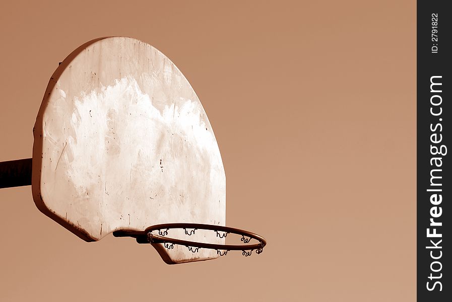 A playground basketball hoop shot in sepia. A playground basketball hoop shot in sepia.