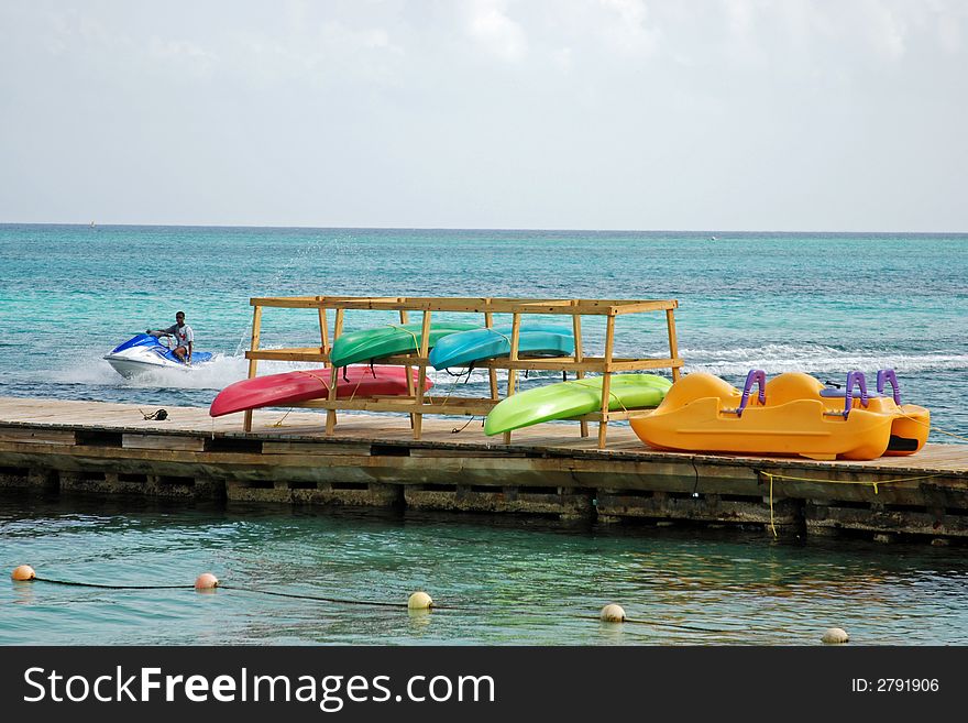 Colorful kayaks hanging to dry. Colorful kayaks hanging to dry