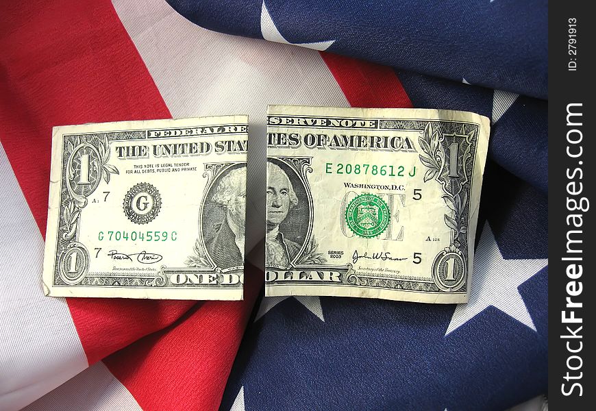 American flag with cash linking patriotism with finiancial interests