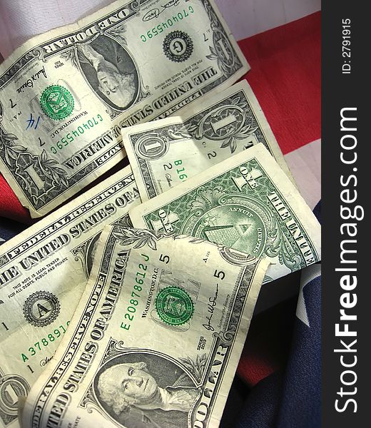 American flag with cash linking patriotism with finiancial interests