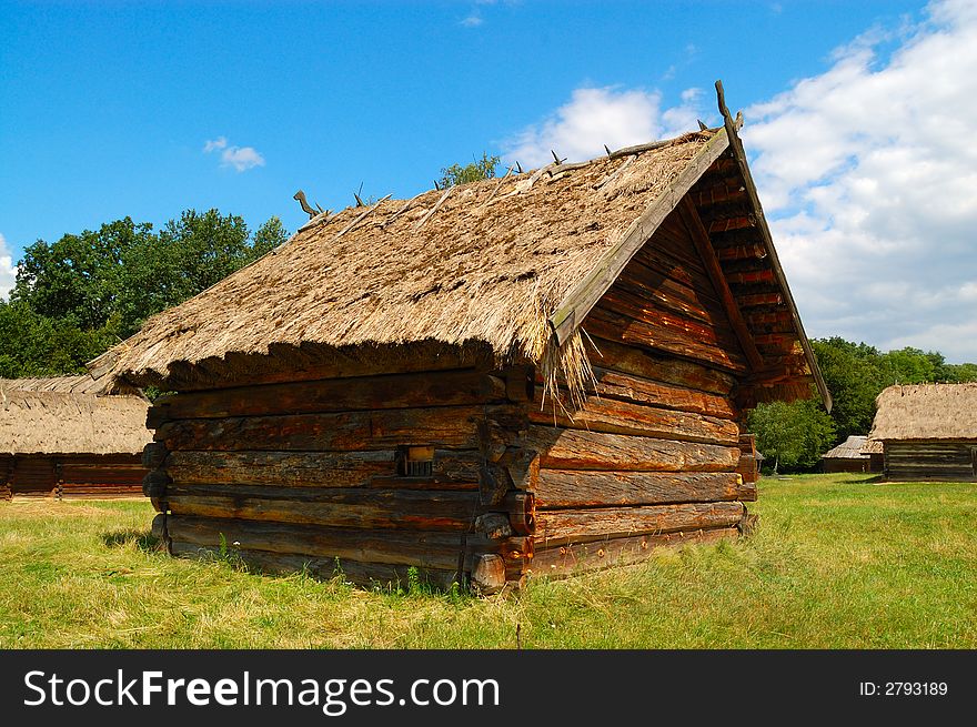 Old Ukrainian wooden hut with thatched roof. Old Ukrainian wooden hut with thatched roof