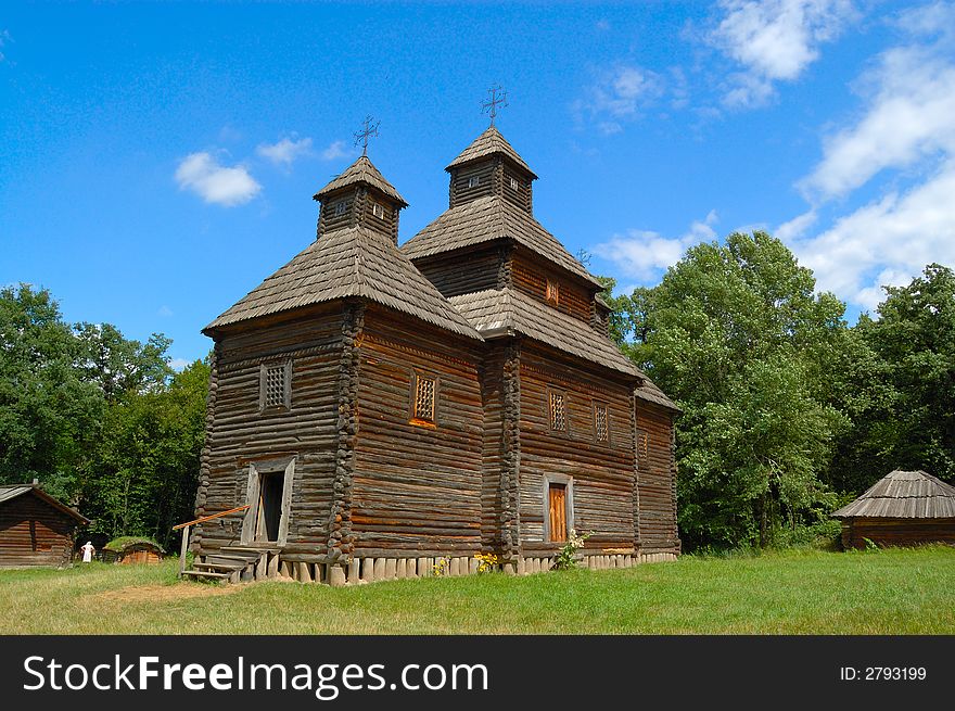 Old  Ukrainian wooden orthodox church  against a cloudy sky. Old  Ukrainian wooden orthodox church  against a cloudy sky