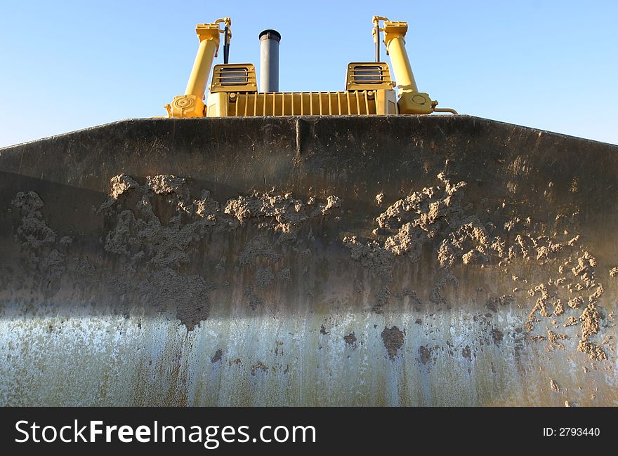 Blade on a large Bulldozer in later afternoon sunlight. Blade on a large Bulldozer in later afternoon sunlight