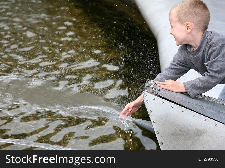 Child near the fountain played with water