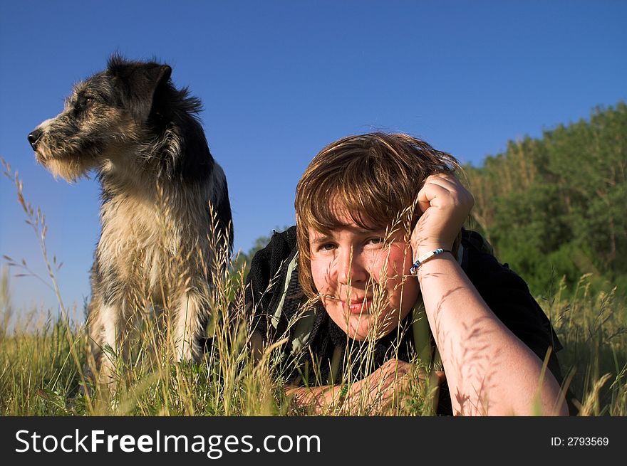 Young woman with dog on meadow