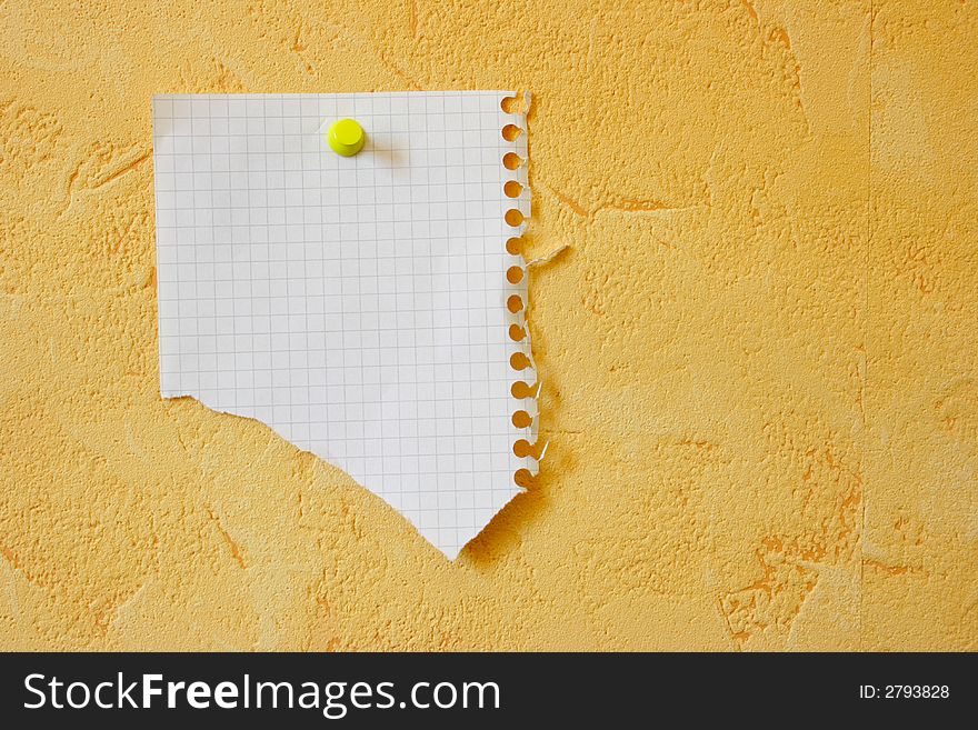 Lacerated blank sheet attached to a yellow wall