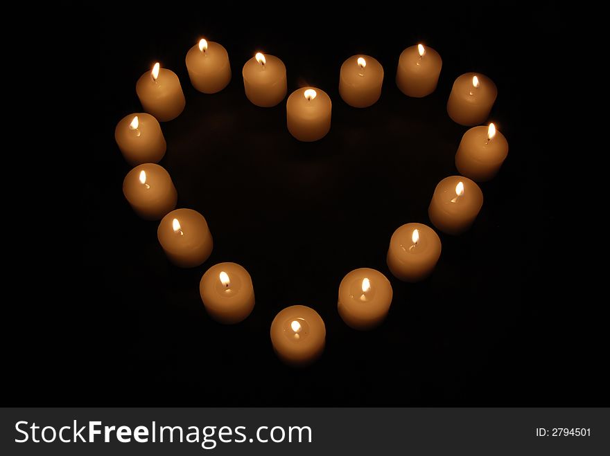 Lit candles in the shape of a heart