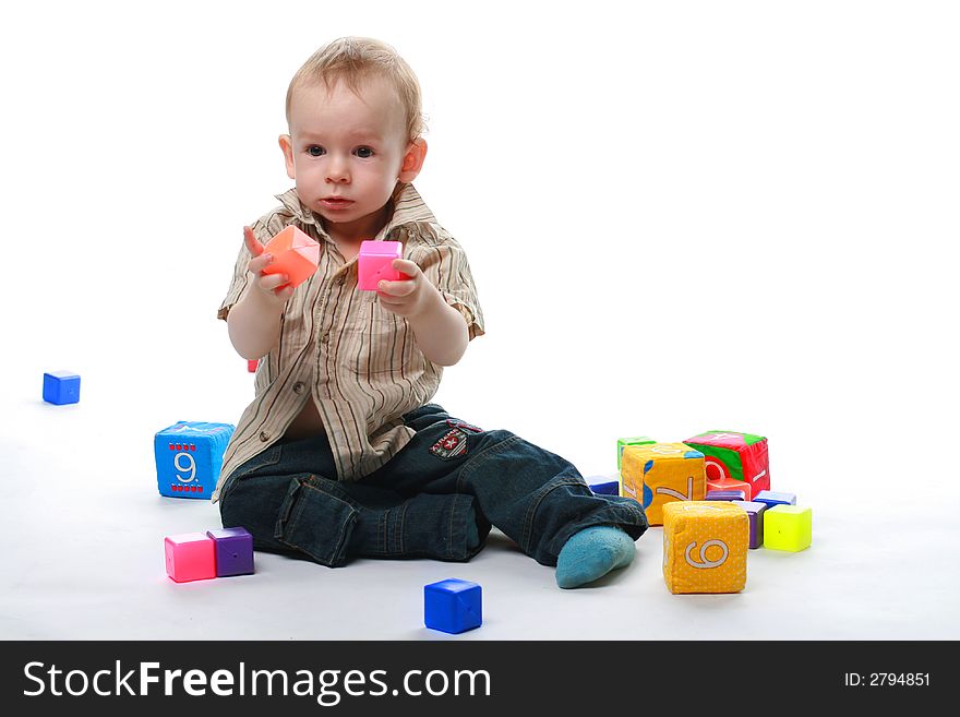 Baby plays cubes on a white background. Baby plays cubes on a white background