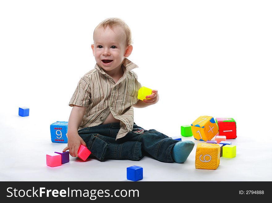 Baby plays cubes on a white background. Baby plays cubes on a white background